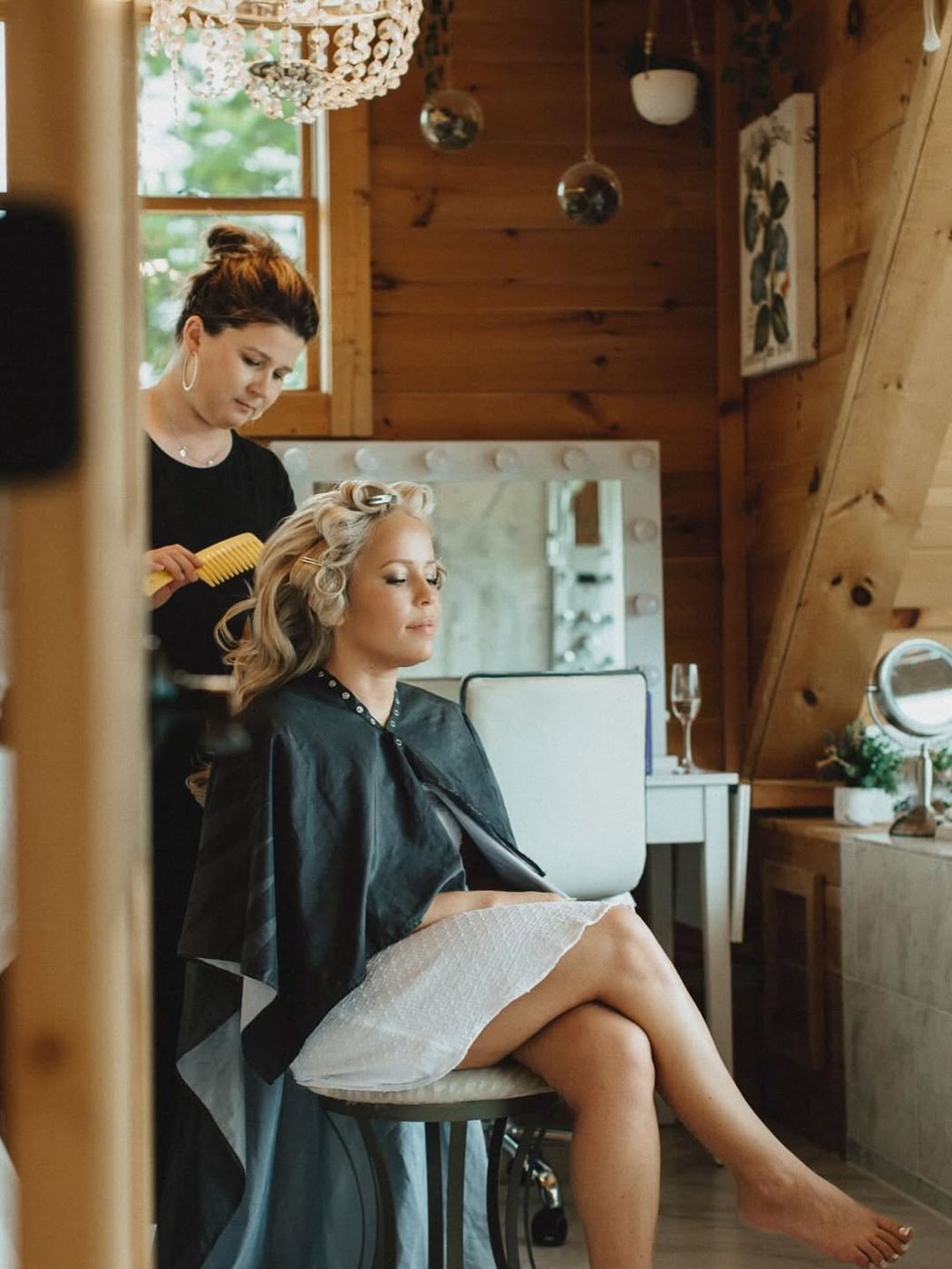 A bride's hair being set in a cabin getting-ready room