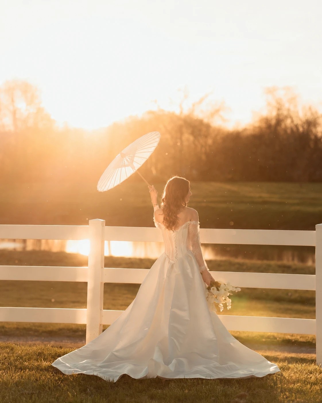 A bride with a paper parasol in golden Smoky Mountain evening light