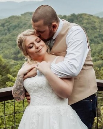 Newlyweds on a cabin deck overlooking the Smoky Mountains