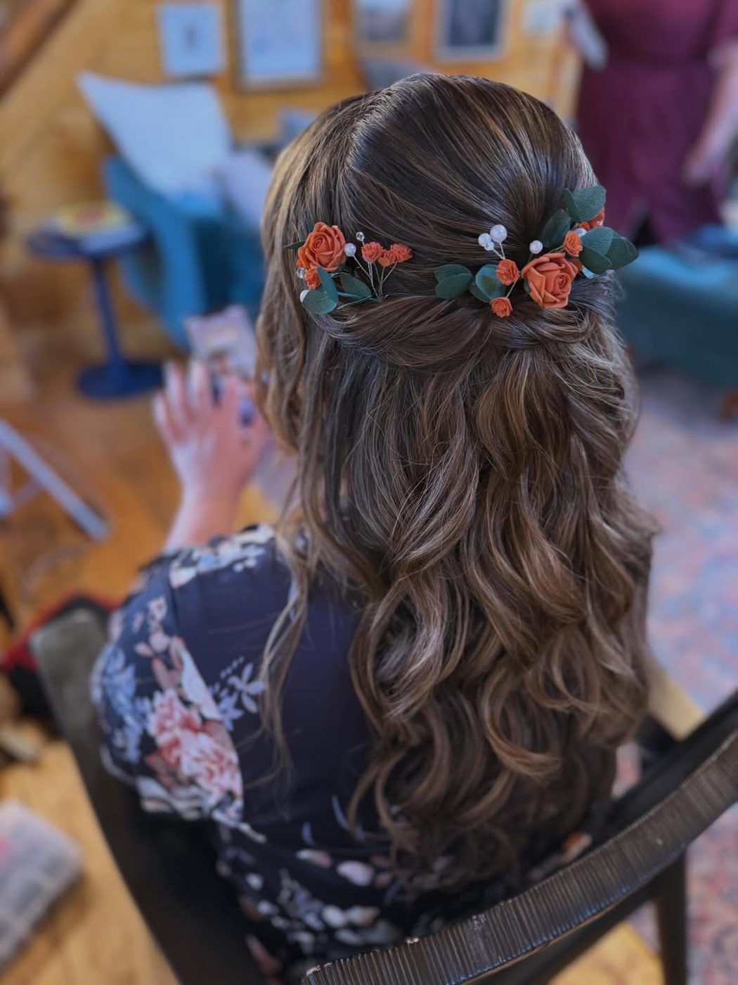 A half-up bridal style dressed with fresh flowers