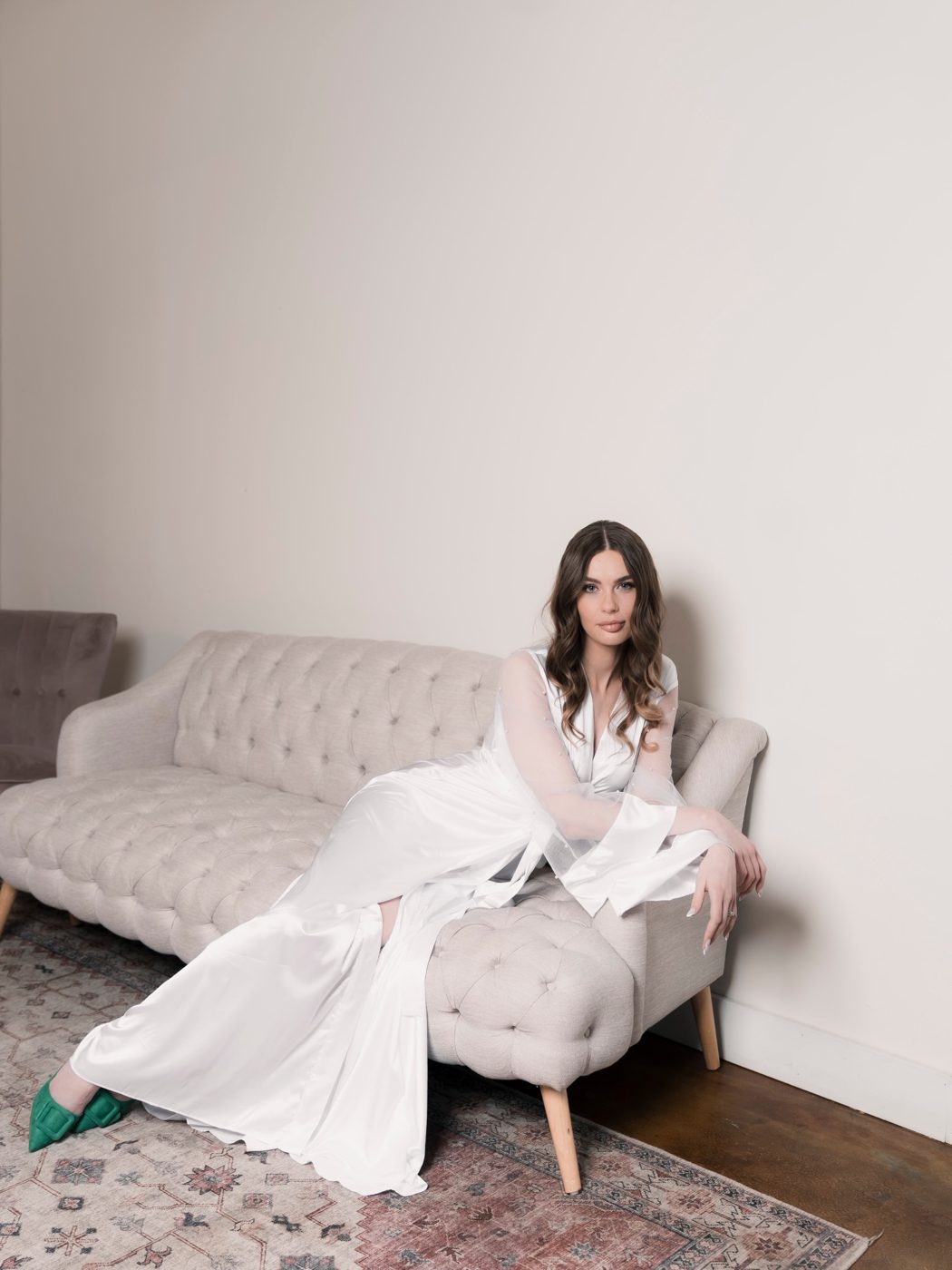 A bride in her robe, photographed in the getting-ready suite